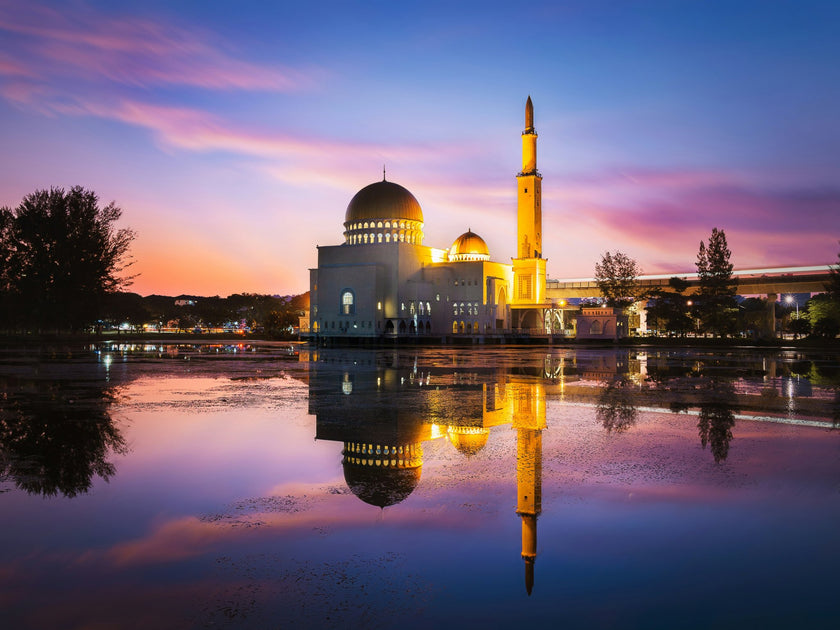 mosque at sunset near a water body